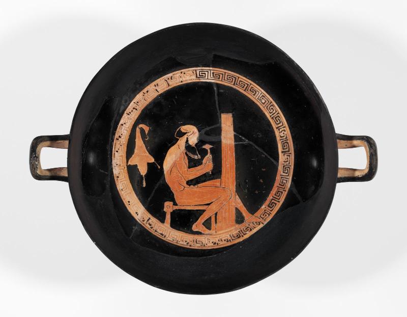 Drinking cup (kylix) with satyr fluting a column