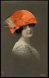 Woman with orange fabric hat, yellow feathers and real hair.
