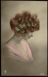 Woman looking down with real hair and fabric flower wreath.
