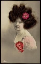 Woman with real hair and fabric flowers in her hair and on her dress.
