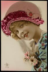 Young girl with rose colored fabric hat.
