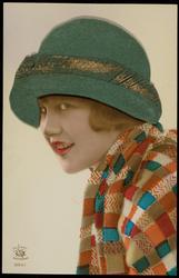 Woman with checkered scarf and green and gold fabric hat.
