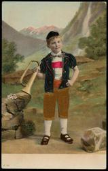 Boy in the countryside with yellow silk knickers and a horn in his hand.
