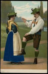 Man and woman in green silk hats dancing in the countryside.
