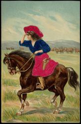 Woman on horseback looking out over the plains.
