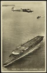 MILITARY PLANE FLYING OVER H.M.S. FURIOUS.
