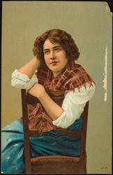 Portrait of woman with red and pink plaid scarf.
