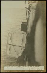 TAKING FIRST WOMAN SURVIVOR ABOARD.
