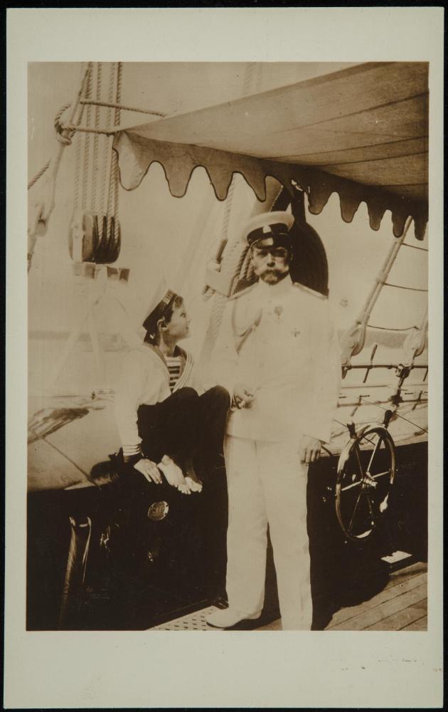 Man and child in Naval attire aboard a boat. Probably Nicholas II and son Alexei.