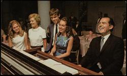 Richard Nixon and family around the piano.