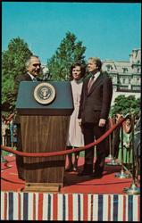 King Hussein of Jordan says a few words from a speaker's stand set up on the White House lawn as he is welcomed by President Carter and Rosalynn. - April 23, 1977