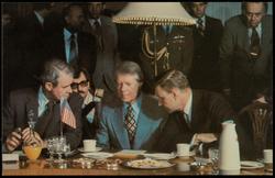Everyone's wearing blue and a serious expression as Secretary of State Cyrus Vance (left) confers with President Carter and Chairman of the National Security Council Zbigniew Brzezinski at a meeting in India. - January, 1978