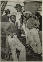 Negro day laborers brought in by truck from nearby towns, waiting to be paid off for cotton picking and to buy supplies inside plantation store, Friday night, Marcella Plantation, Mileston, Mississippi Delta Mississippi, October 1939