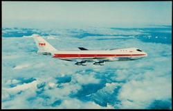TWA airplane above the clouds.