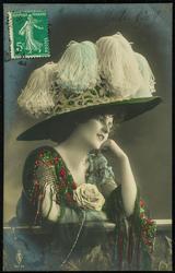 Woman in a big white feathery hat.