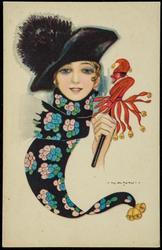 Woman with patterned scarf and a jester puppet.