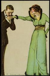 Man kissing the hand of a woman dressed in light green.