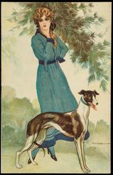 Portrait of a woman in a long blue dress with a tall brown and white dog.