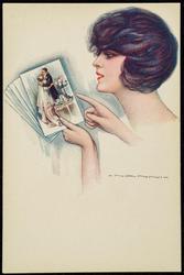 Woman looking at photos of a couple in a romantic embrace.