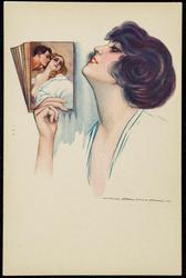 Woman looking at photos of a couple in a romantic embrace.