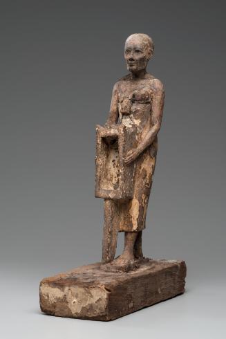 Statuette of a man holding a naos