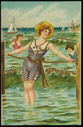 Woman leaning on a rope fence at the beach.