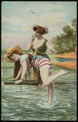 Two women messing around at the beach.