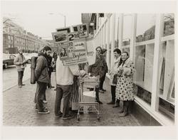 (Elsa selling photographs in Harvard Square)