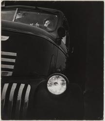 Untitled (Man behind wheel of truck, headlight on)