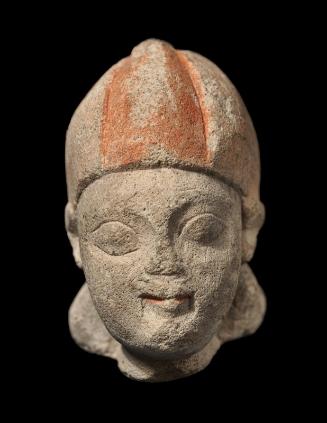 Head of a beardless male wearing a conical helmet