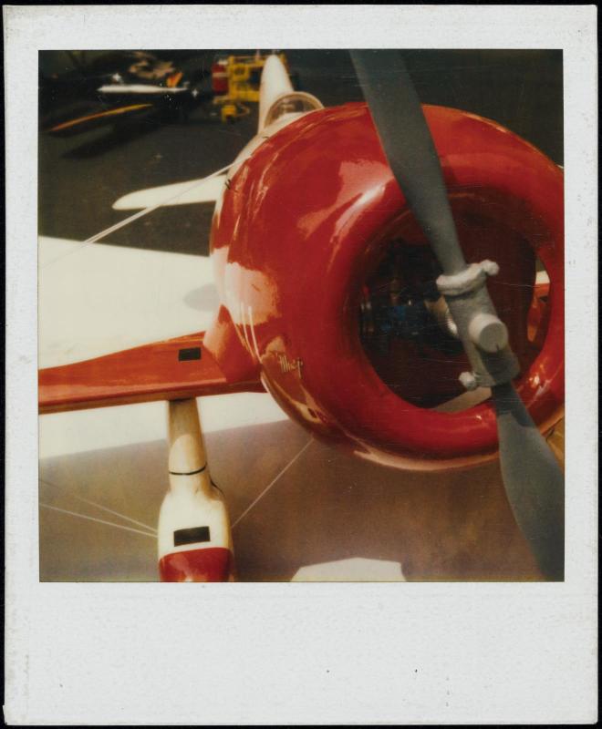 Close-up view of red airplane and propeller
