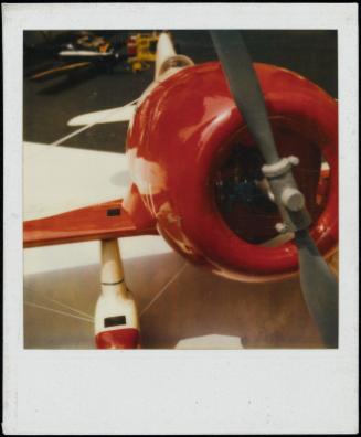 Close-up view of red airplane and propeller