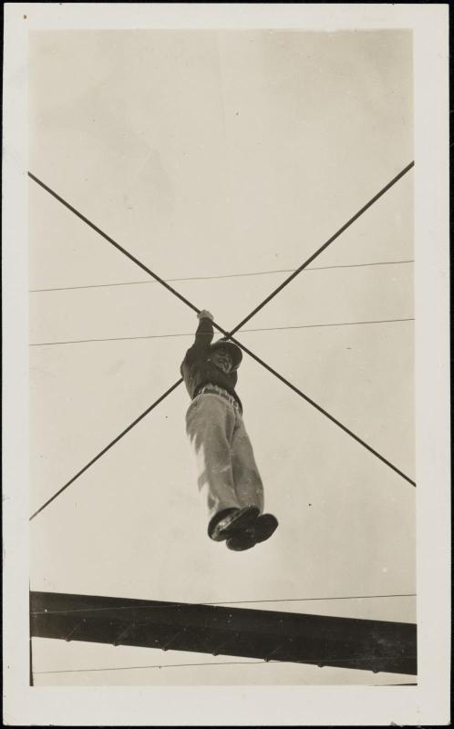 Man hanging from crossed wires