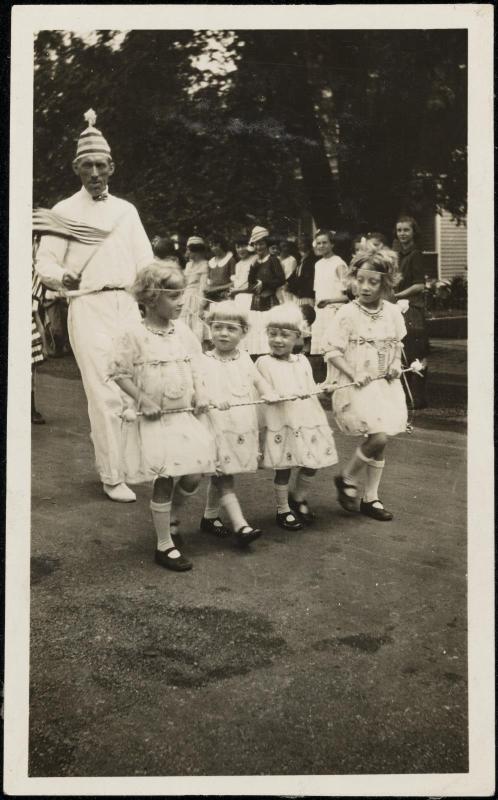Four girls in white dresses in July 4 parade