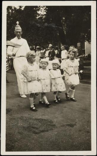 Four girls in white dresses in July 4 parade