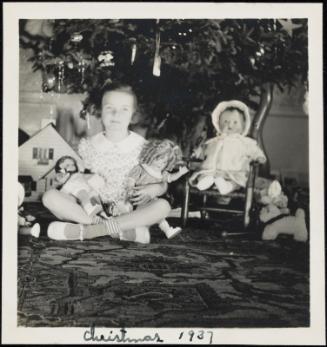 Girl with dolls (including Shirley Temple) on Christmas