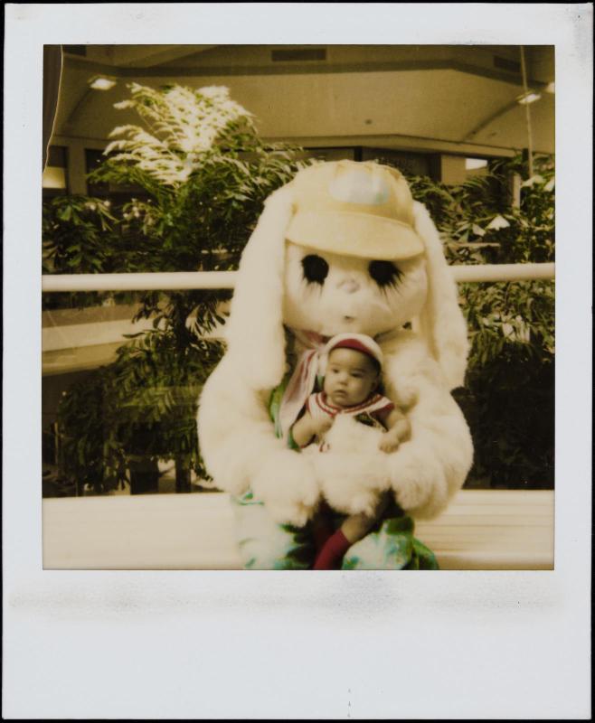 Baby being held by giant bunny