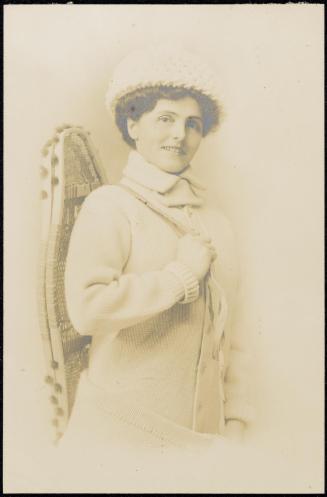 Woman with snowshoes and winter clothes