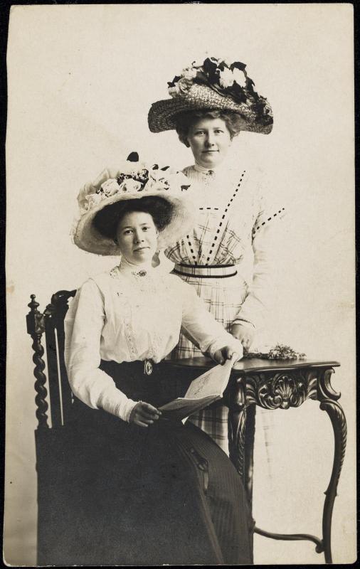 Two women with large flowered hats