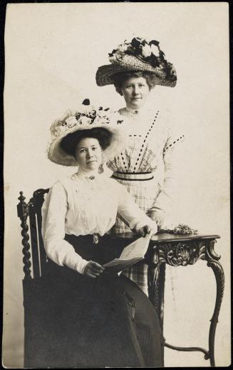 Two women with large flowered hats