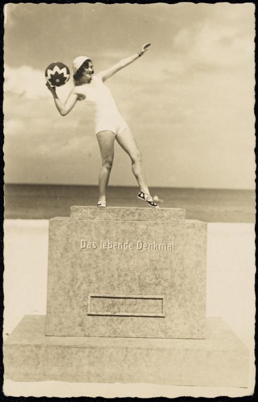 Woman on pedestal with ball in hand