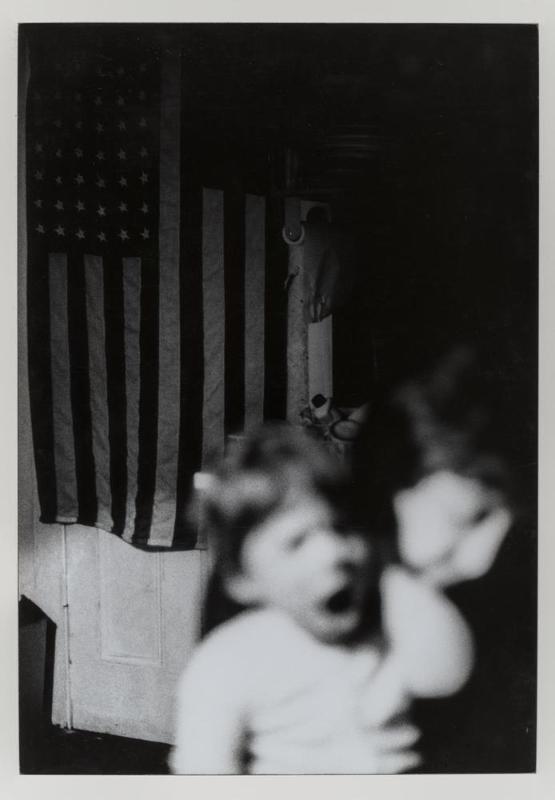 Untitled (boy with flag in background)