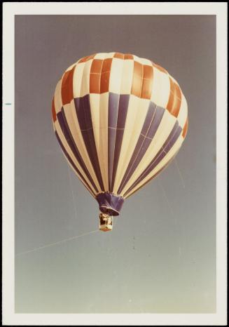 Red, white and blue hot air balloon in sky