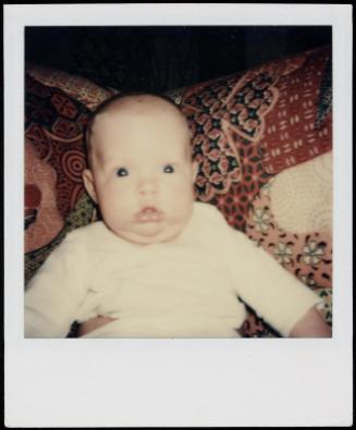 Close-up of baby stunned by flash
