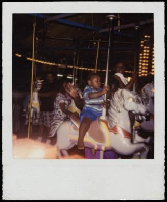 African American children on carousel horses
