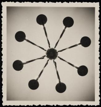 Abstract form with spokes and circles emanating from center