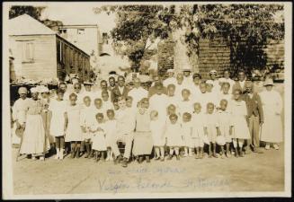 Sam and Edith Elfstrom seated amongst large group of people, Virgin Islands, Saint Thomas