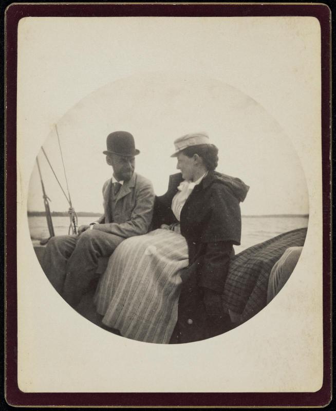 Circular Kodak portrait of man and woman seated on a boat