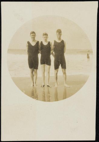 Circular Kodak portrait of three young men in bathing suits by the shore