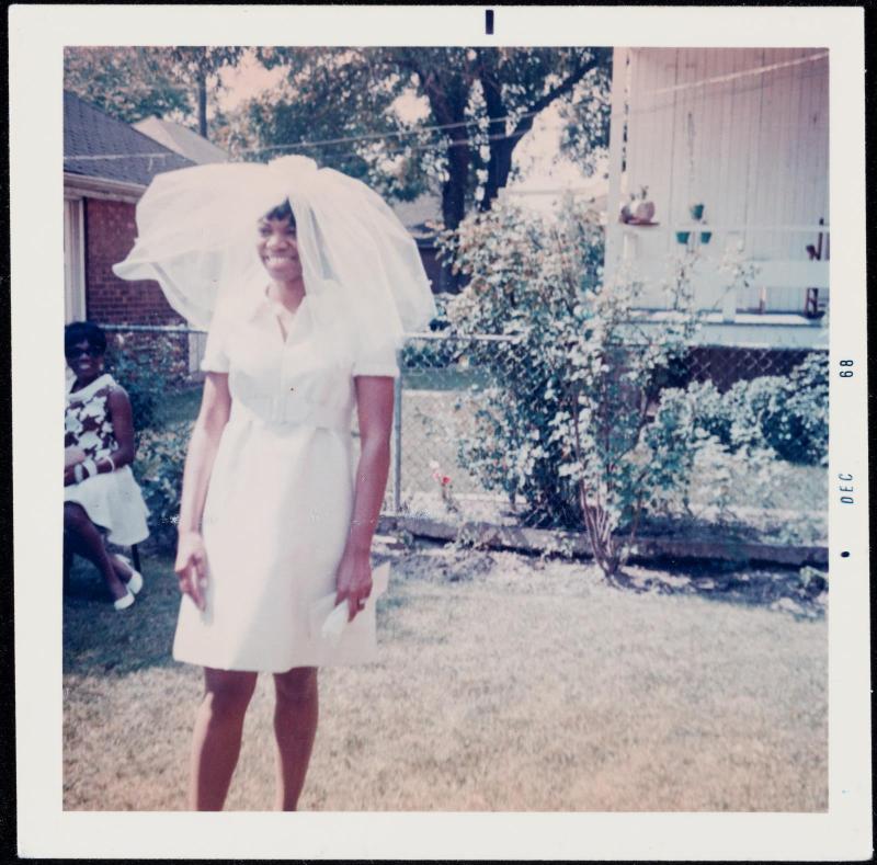 Portrait of a bride with veil and short dress outdoors